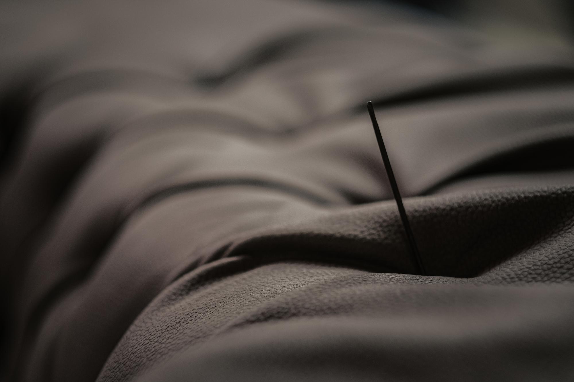 Close-up of satin stitch on dark fabric